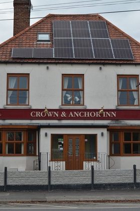 Crown & Anchor Inn exterior with solar panels on the roof